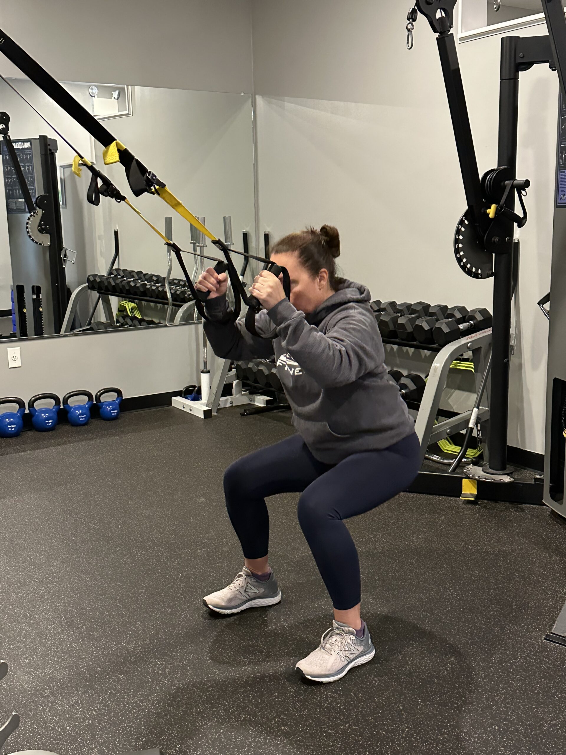 Female personal trainer on a TRX machine