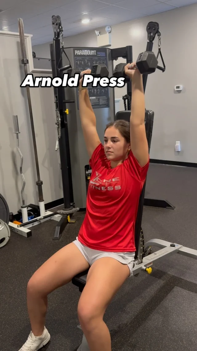 📣Trainer Tip Tuesday: Mastering the Arnold Press💪🏼🏋🏻‍♀️ This exercise targets the shoulders, triceps, and upper chest. 🚨Positioning: 1) sit on a bench upright with your feet spread apart and dumbbells in each hand. 2) hold the dumbbells in front of your face with your palms facing inward and elbows bent 90 degrees. 🚨Execution: 1) began by pressing the dumbbells outward keeping the elbows at a 90 degree angle. 2) Then press the dumbbells upward, extending your arms. 3) Slowly reverse the motion, bringing the dumbbells back down and then inward. #zonefitness #strengthtraining #shoulderwork #arnoldpress #dumbbellworkout